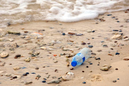 Environmental pollution: plastic bottle on the beach.の写真素材