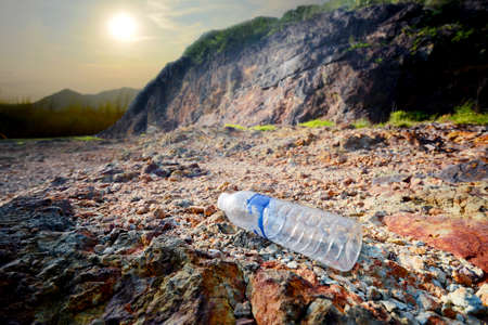 Plastic water bottle garbage on the background of mountains and sky Ecological disaster. Environmental obstructionの写真素材