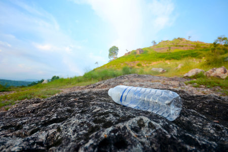 Plastic water bottle garbage on the background of mountains and sky Ecological disaster. Environmental obstructionの写真素材