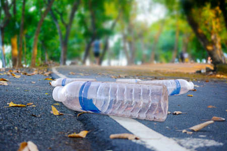 Drinking water bottles are strewn downstairs in a green park to clean up the environment.の写真素材