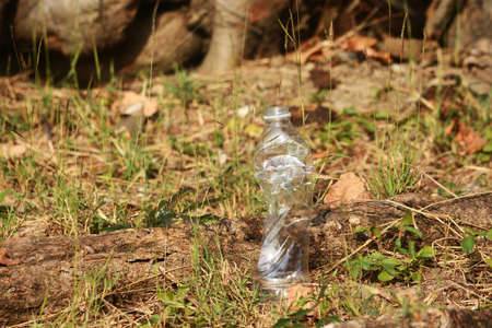 a plastic bottle lies on grass in nature like garbageの写真素材