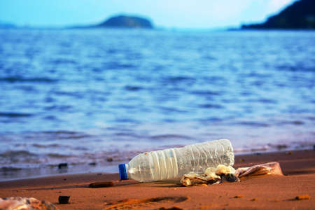 Environmental pollution: plastic bottle on the beach.の写真素材