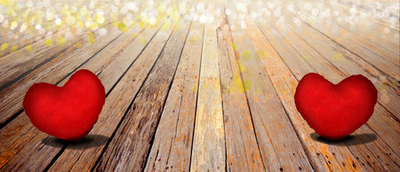 Valentines day background with two red hearts on wooden backgroundの素材