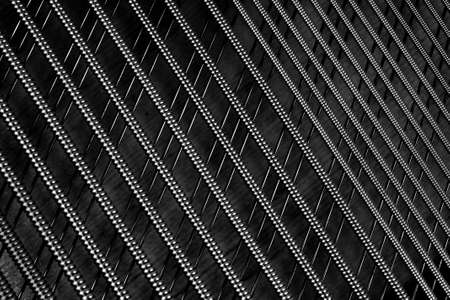 Black and white diagonal crossing piano strings close upの写真素材