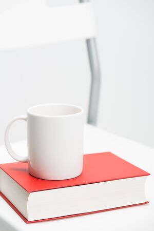A mug on a bookの写真素材