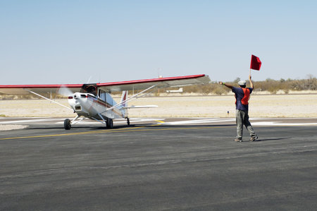 An airshow visitor is directed to the aircraft parking area.