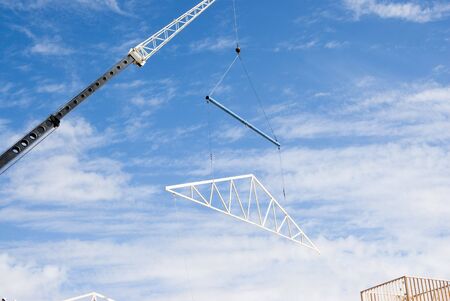 roof trusses being put in place at a construction siteの写真素材