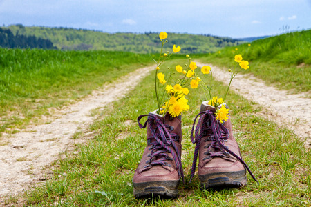 Hiking boots on a country laneの写真素材