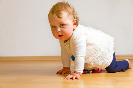 Baby on parquet floorの写真素材