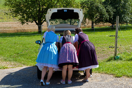 Three girls on a little white carの写真素材