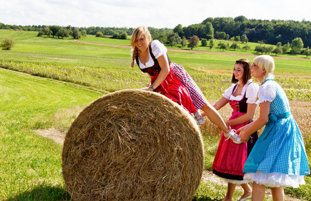 Happy girls in colorful dirndl having funの写真素材