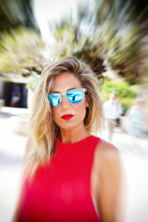 Cool blond woman with sunglasses - zoom effectの写真素材