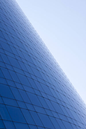 Blue glass windows building facade and sky background.の写真素材