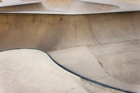 Background of an empty bowl with rails in a concrete skate park.の写真素材