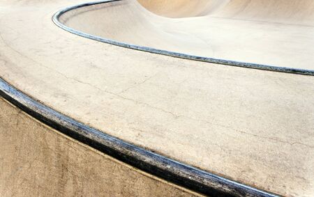 Background of an empty bowl with rails in a concrete skate park.の写真素材