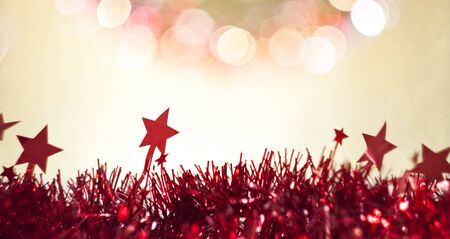 Red stars christmas ribbon decoration on bokeh pastel shades background.の写真素材