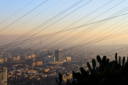 Barcelona, Spain - January 14, 2011: Cityscape of Barcelona city under the pollution smog on January 14, 2011. View from the mountain with high tension lines.のeditorial素材