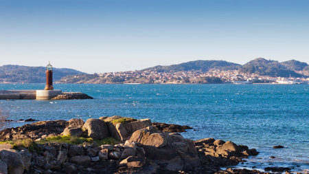 View of Vigo estuary and Sea Museum beacon from Carril beach. Cangas do Morrazo village at background.の写真素材