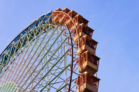 Big colorful ferris wheel with blue sky background