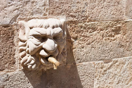 Gothic stone head of public Fontain of the Church in Solsona, Lleida, Catalonia, Spain.の写真素材