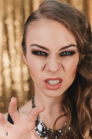 exquisite lady passionate woman on a gold backgroundの写真素材