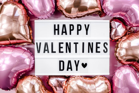 Stylish text frame lightbox with the inscription happy Valentine's day. Pink and beige hearts all...
