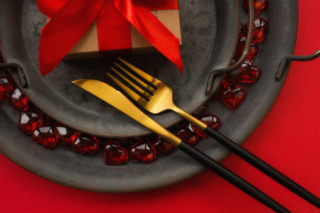 Festive table setting.Heart on a fork close-up. Holiday concept. Valentine's Day. Copy space for inscriptions.の写真素材