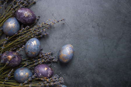 Easter card with a copy of the place for the text. Purple, blue and golden eggs with lavender on a...