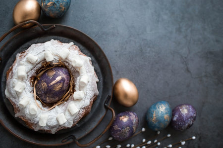 Easter card with a copy of the place for the text. Purple, blue and golden eggs with a cake on a...