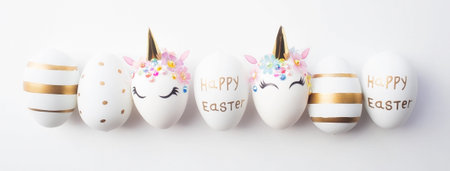 Banner. Easter eggs in the form of a unicorn, and with a gold pattern on a white background. flat...