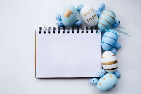 Blue and white easter eggs on a white isolated background. geometry. Minimal easter concept. view from above. Easter card with copy space for text.の写真素材