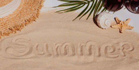 The concept of a holiday at the sea. Shells, a straw hat, sunglasses and the word summer on the...