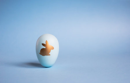 Easter painted eggs isolated on trendy blue background. The minimum concept. Card with copy space...