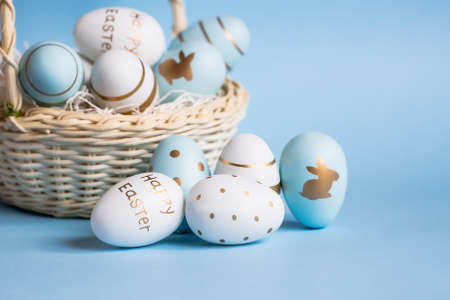 Easter painted eggs isolated on trendy blue background. The minimum concept. Card with copy space for text.の写真素材