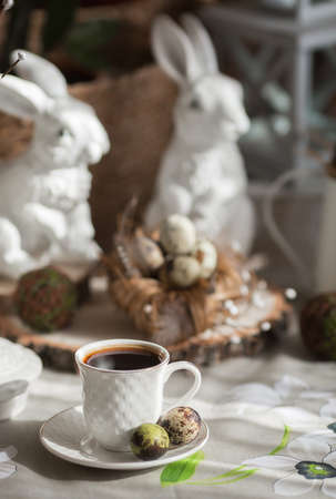 Blue Easter eggs in a nest on a wooden background. Easter card with a place to copy the text. The concept of bright Easter.の写真素材