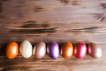 Colored easter eggs on a wooden background. Happy Easter.の写真素材