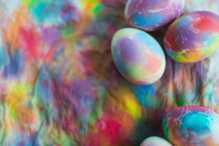 Bright, multi-colored Easter eggs on a colorful background. minimal concept. Card with copy space...