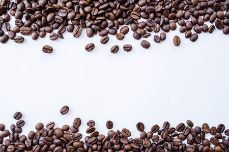 Roasted coffee beans on a white background. Space for text.