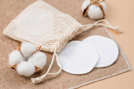 Cotton pads and cotton flowers on a beige background. Zero waste concept.の写真素材