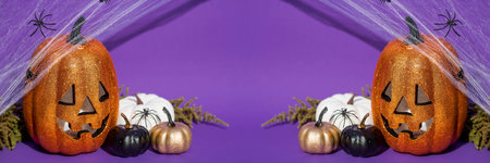 Halloween pumpkins with spiders and cobwebs on purple background, bannerの写真素材