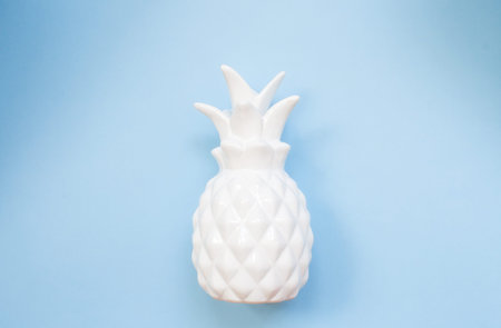White pineapple on blue background. Minimal summer concept with copy space.の写真素材
