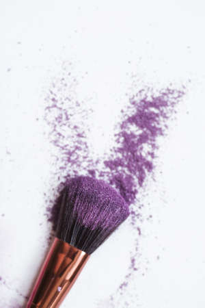 Banner.Purple eye shadow and makeup brush isolated on a white background. Concept, fashion, beauty and facial care.の写真素材