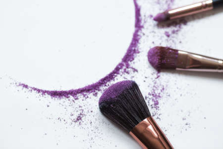 Eye shadow and makeup brush highlighted on a white background. A frame for the beauty industry. The concept of beauty and self-care.の写真素材