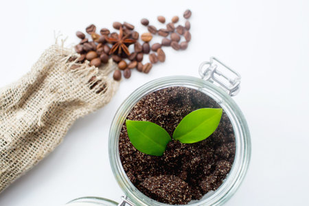 Coffee beans in a glass jar on a white background.