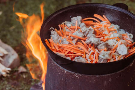 Recipe for traditional oriental pilaf in a cauldron in nature. Cooking. recipes. Step by step photo instructions for cooking pilaf.の写真素材