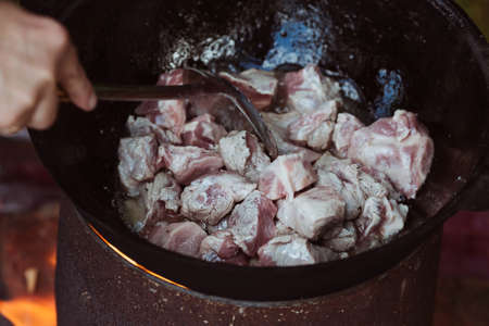 Recipe for traditional oriental pilaf in a cauldron in nature. Cooking. recipes. Step by step photo instructions for cooking pilaf.の写真素材