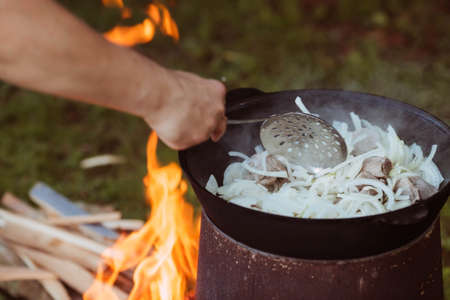 Recipe for traditional oriental pilaf in a cauldron in nature. Cooking. recipes. Step by step photo instructions for cooking pilaf.の写真素材