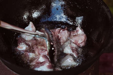 Recipe for traditional oriental pilaf in a cauldron in nature. Cooking. recipes. Step by step photo instructions for cooking pilaf.の写真素材