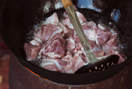 Recipe for traditional oriental pilaf in a cauldron in nature. Cooking. recipes. Step by step photo instructions for cooking pilaf.の写真素材