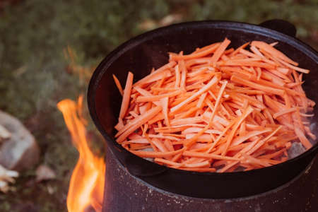 Recipe for traditional oriental pilaf in a cauldron in nature. Cooking. recipes. Step by step photo instructions for cooking pilaf.の写真素材